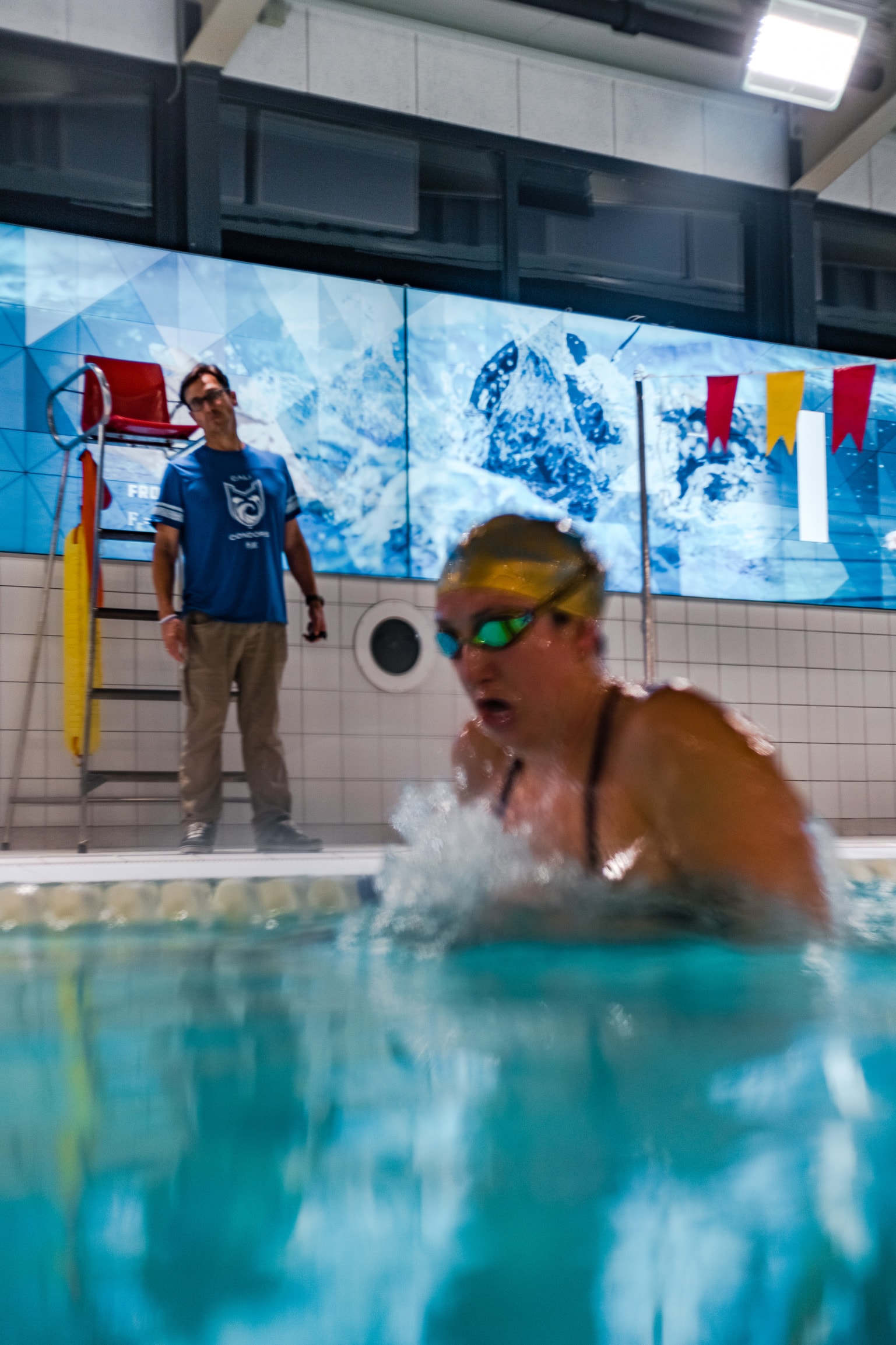 Jeff Julian coaching a swimmer at the pool wall