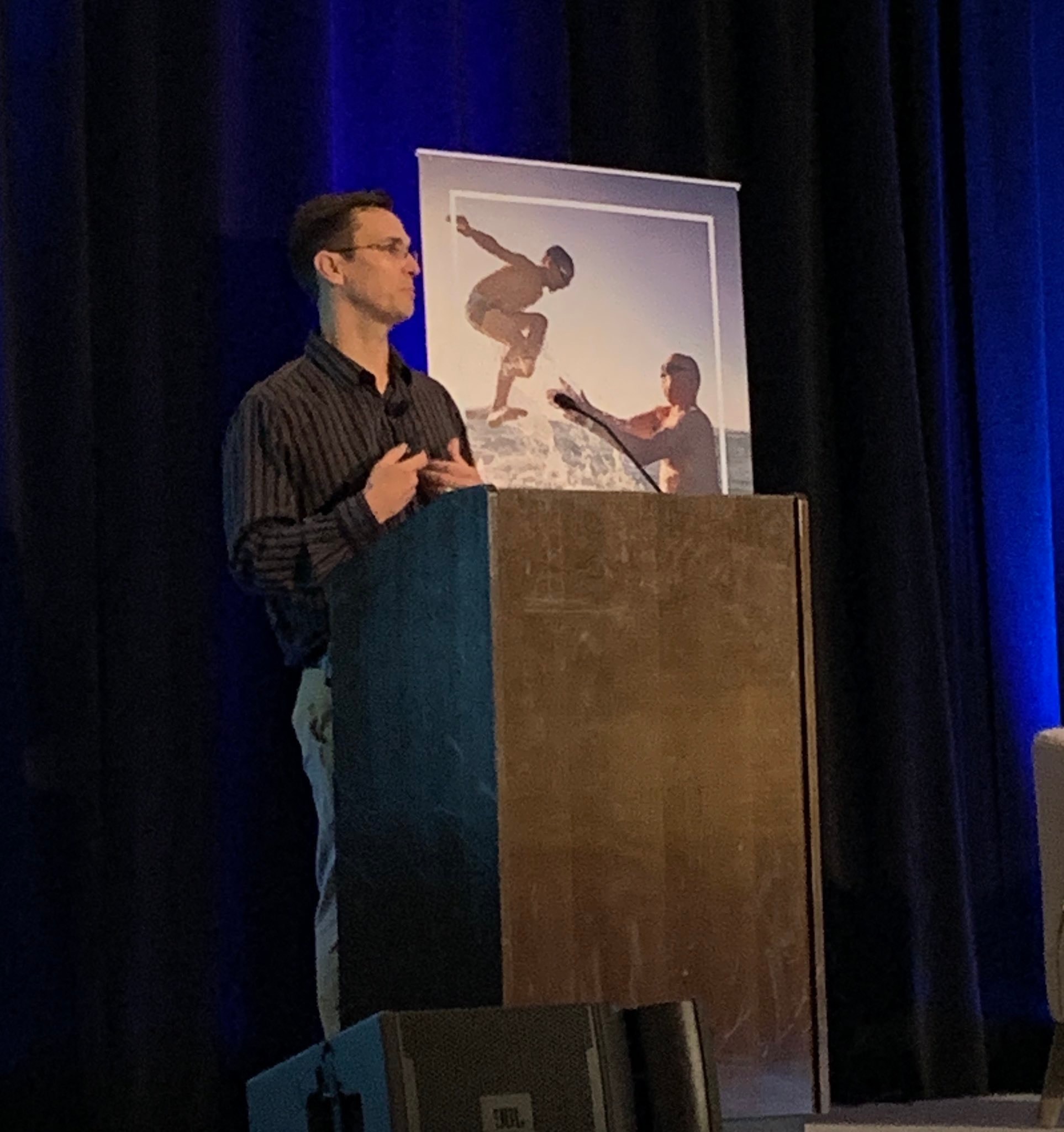 Jeff Julian speaking at a conference podium